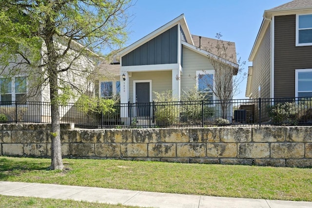 5400 Golden Canary Ln Unit 49, Austin, TX 78723 - view of front facade featuring a front lawn, fence, and board and batten siding
