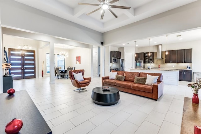 15089 Joseph Dr, Austin, TX 78734 - living area featuring a chandelier, ceiling fan, coffered ceiling, light tile patterned floors, and beam ceiling
