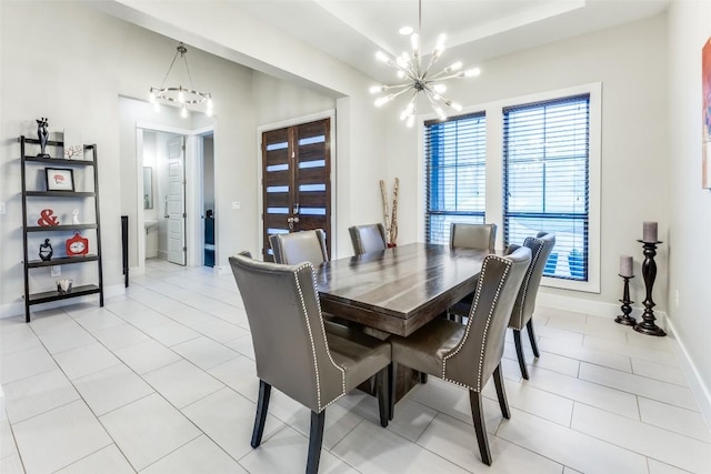 15089 Joseph Dr, Austin, TX 78734 - dining area featuring a chandelier, a raised ceiling, and light tile patterned floors