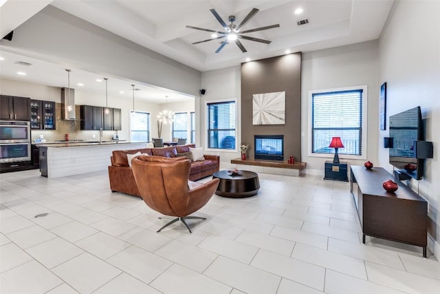 15089 Joseph Dr, Austin, TX 78734 - living room with recessed lighting, ceiling fan, a fireplace, a high ceiling, and beamed ceiling