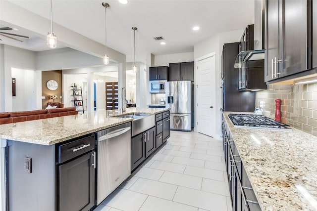 15089 Joseph Dr, Austin, TX 78734 - kitchen featuring stainless steel appliances, open floor plan, tasteful backsplash, light stone countertops, and light tile patterned floors