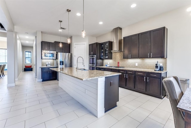 15089 Joseph Dr, Austin, TX 78734 - kitchen featuring stainless steel appliances, wall chimney exhaust hood, tasteful backsplash, decorative light fixtures, and dark brown cabinets
