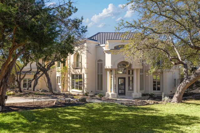 19801 Angel Bay Dr, Spicewood, TX 78669 - mediterranean / spanish-style house featuring stucco siding, a front lawn, and a tile roof