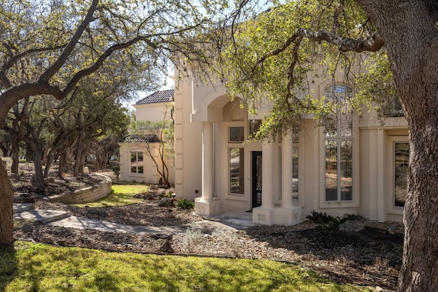19801 Angel Bay Dr, Spicewood, TX 78669 - view of side of home with stucco siding and a tiled roof