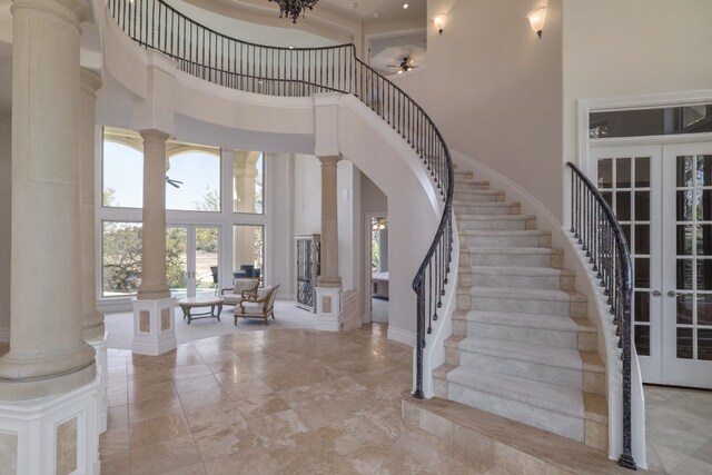 19801 Angel Bay Dr, Spicewood, TX 78669 - entrance foyer with a high ceiling, ornate columns, healthy amount of natural light, a ceiling fan, and stairs