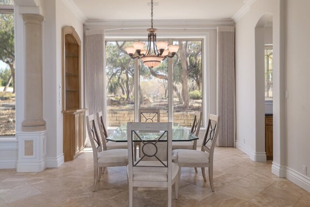 19801 Angel Bay Dr, Spicewood, TX 78669 - dining room with a chandelier, healthy amount of natural light, arched walkways, and crown molding