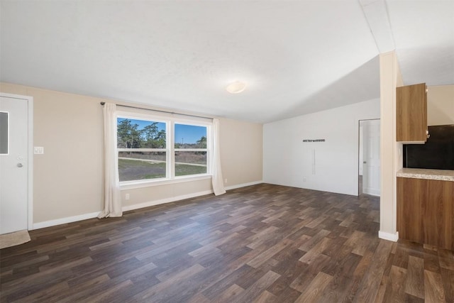 1139 E Old Hallettsville Rd, Flatonia, TX 78941 - unfurnished living room with baseboards, dark wood-style flooring, and vaulted ceiling