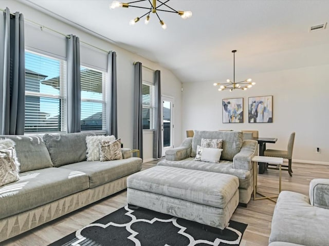 218 Pearland St, Hutto, TX 78634 - living area with a chandelier, light wood-type flooring, lofted ceiling, and baseboards