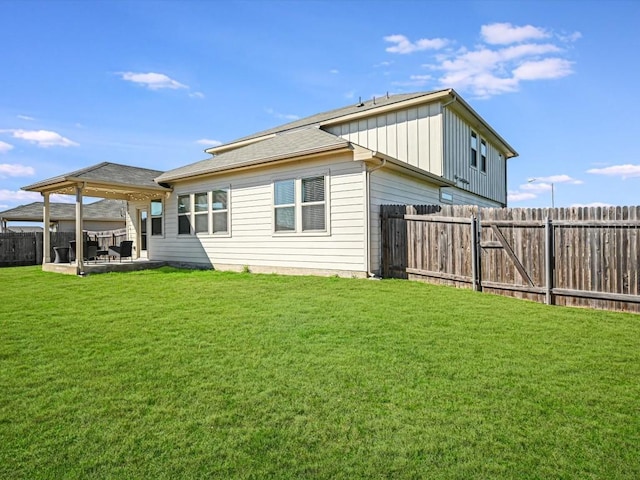 218 Pearland St, Hutto, TX 78634 - back of property featuring board and batten siding and a patio