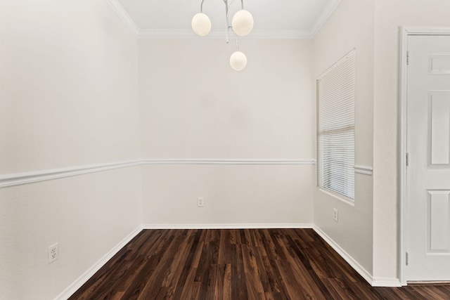 spare room featuring baseboards, wood finished floors, and ornamental molding