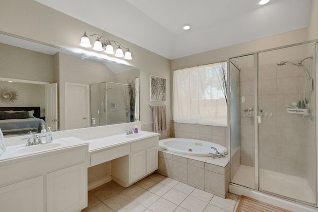 full bathroom featuring a stall shower, tile patterned flooring, double vanity, a tub with jets, and ensuite bathroom