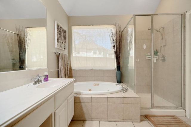 full bathroom with a stall shower, a whirlpool tub, tile patterned flooring, and vanity