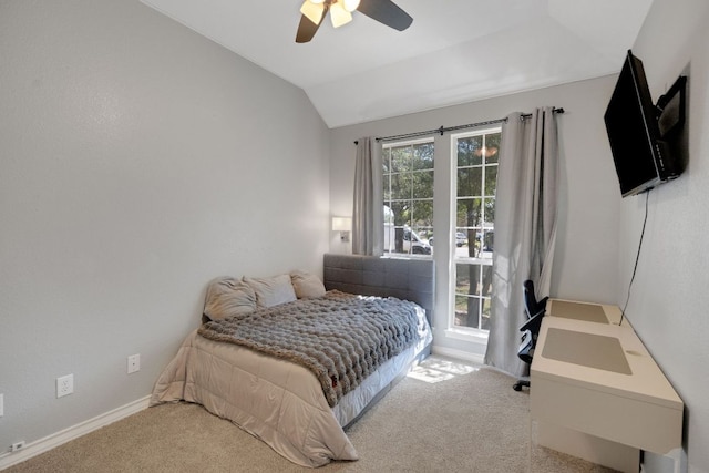 carpeted bedroom featuring vaulted ceiling, a ceiling fan, and baseboards
