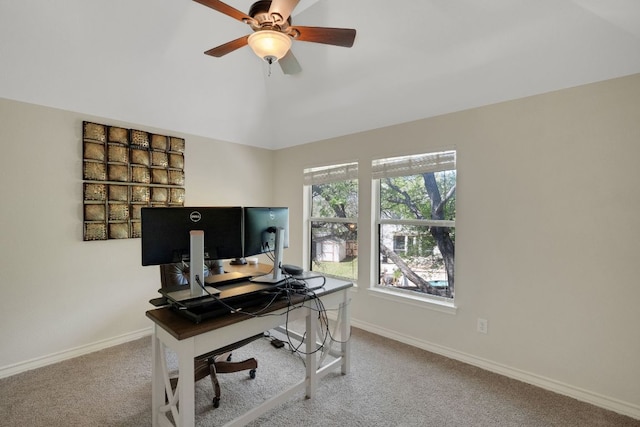 home office featuring carpet flooring, baseboards, a ceiling fan, and vaulted ceiling
