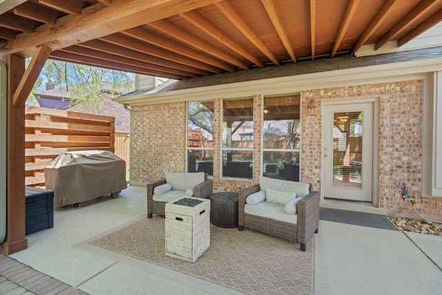 view of patio / terrace featuring a grill and fence