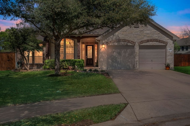 view of front of property featuring a garage, concrete driveway, and stone siding