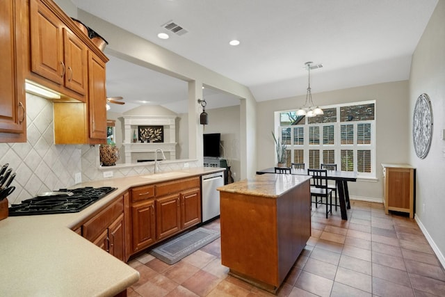 kitchen with black gas stovetop, a sink, a chandelier, dishwasher, and light countertops