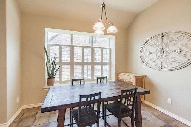 dining space featuring healthy amount of natural light, a chandelier, lofted ceiling, light tile patterned floors, and baseboards