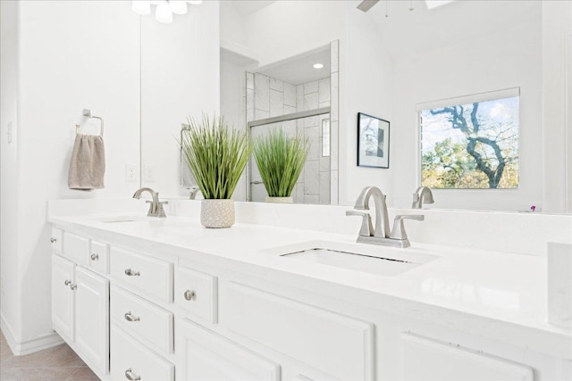 full bath with a shower stall and double vanity