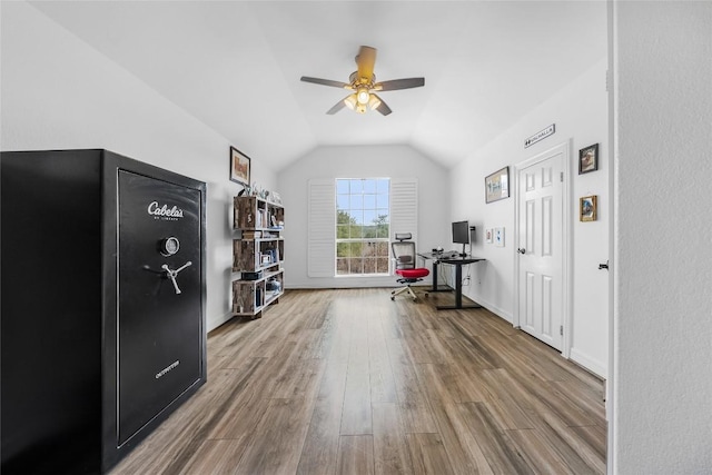 workout area featuring baseboards, lofted ceiling, ceiling fan, and wood finished floors