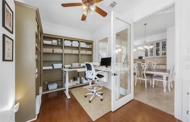 office area featuring crown molding, visible vents, ceiling fan with notable chandelier, and wood finished floors