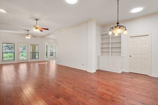 183 Augusta Dr, Wimberley, TX 78676 - unfurnished room featuring hardwood / wood-style floors, crown molding, a ceiling fan, baseboards, and built in features