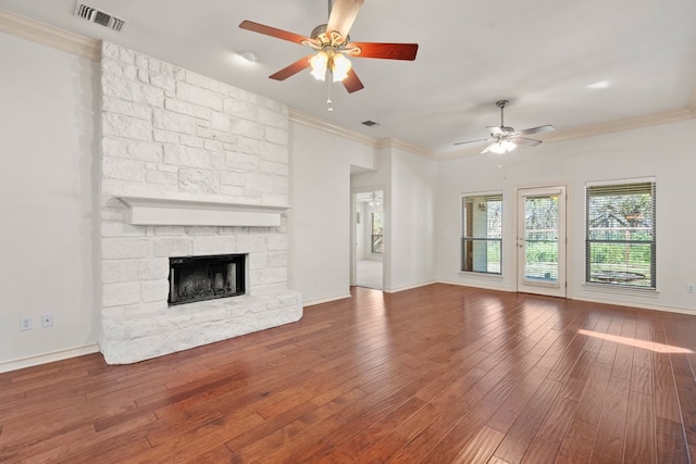183 Augusta Dr, Wimberley, TX 78676 - unfurnished living room featuring a ceiling fan, ornamental molding, wood-type flooring, a fireplace, and baseboards
