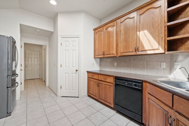 183 Augusta Dr, Wimberley, TX 78676 - kitchen featuring dishwasher, freestanding refrigerator, a sink, decorative backsplash, and light tile patterned floors
