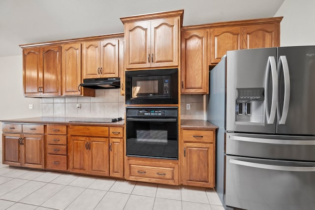 183 Augusta Dr, Wimberley, TX 78676 - kitchen with black appliances, under cabinet range hood, backsplash, and brown cabinetry
