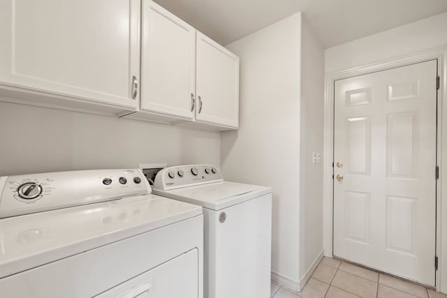 183 Augusta Dr, Wimberley, TX 78676 - laundry room with separate washer and dryer, light tile patterned floors, cabinet space, and baseboards