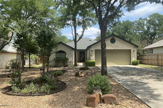 183 Augusta Dr, Wimberley, TX 78676 - single story home with stone siding, an attached garage, and driveway