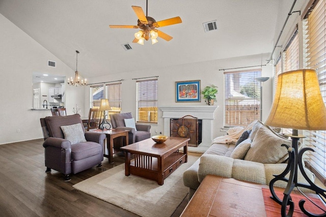 1015 Strickland Dr, Austin, TX 78748 - living area featuring ceiling fan, wood finished floors, high vaulted ceiling, a chandelier, and a fireplace with raised hearth