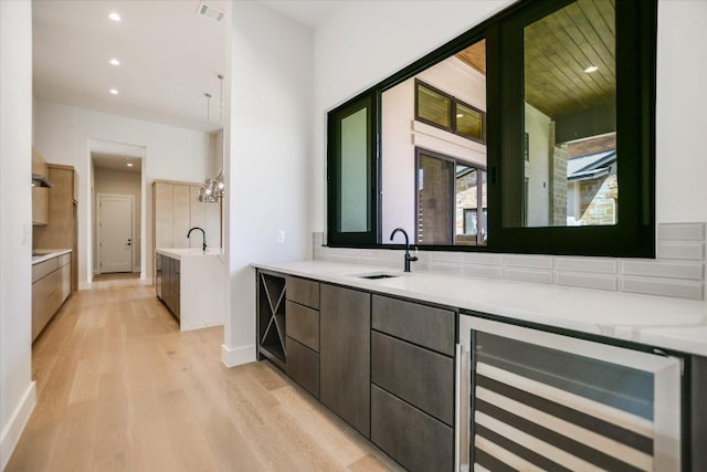 123 Azalea Loop, Horseshoe Bay, TX 78657 - full bathroom with wine cooler, wood finished floors, a bath, vanity, and recessed lighting