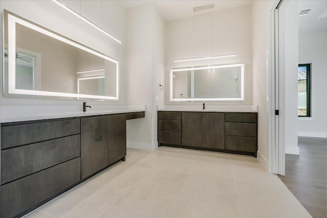 123 Azalea Loop, Horseshoe Bay, TX 78657 - full bathroom with two vanities, baseboards, and tile patterned flooring