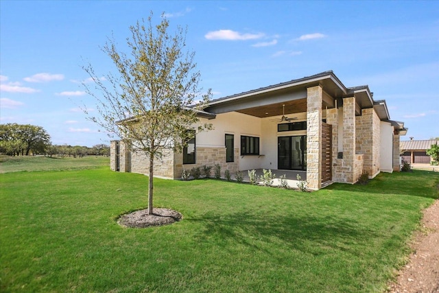 123 Azalea Loop, Horseshoe Bay, TX 78657 - rear view of house featuring a ceiling fan, stone siding, a yard, and stucco siding