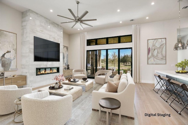 123 Azalea Loop, Horseshoe Bay, TX 78657 - living area with recessed lighting, a ceiling fan, wood finished floors, a premium fireplace, and baseboards
