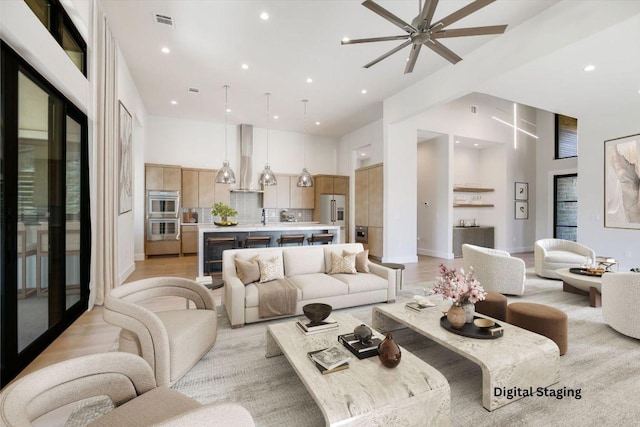 123 Azalea Loop, Horseshoe Bay, TX 78657 - living area with a high ceiling, recessed lighting, ceiling fan, baseboards, and light wood finished floors