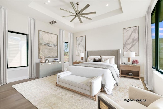 123 Azalea Loop, Horseshoe Bay, TX 78657 - bedroom featuring a raised ceiling, wood finished floors, baseboards, recessed lighting, and a ceiling fan