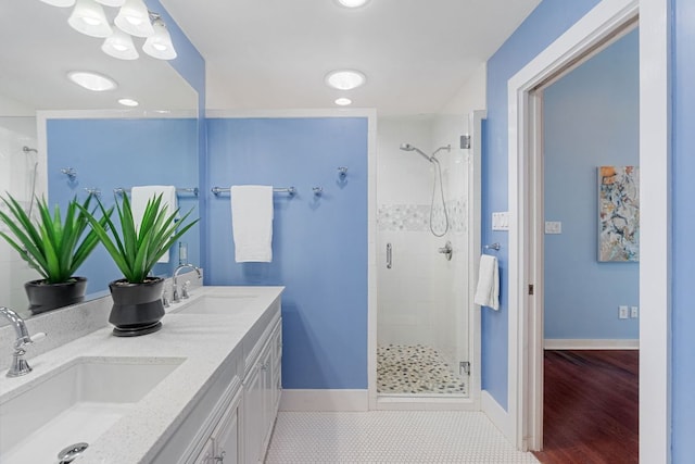 4419 Sinclair Ave, Austin, TX 78756 - bathroom featuring a stall shower, double vanity, and baseboards