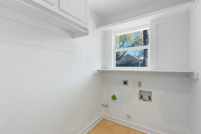 4419 Sinclair Ave, Austin, TX 78756 - laundry room with cabinet space, light tile patterned floors, hookup for an electric dryer, baseboards, and hookup for a washing machine