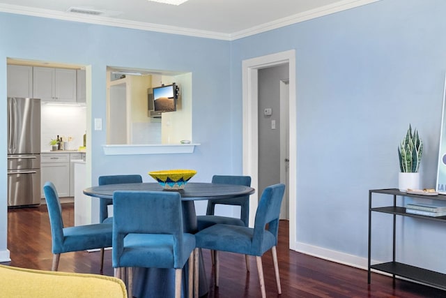 4419 Sinclair Ave, Austin, TX 78756 - dining space with wood finished floors, ornamental molding, and baseboards