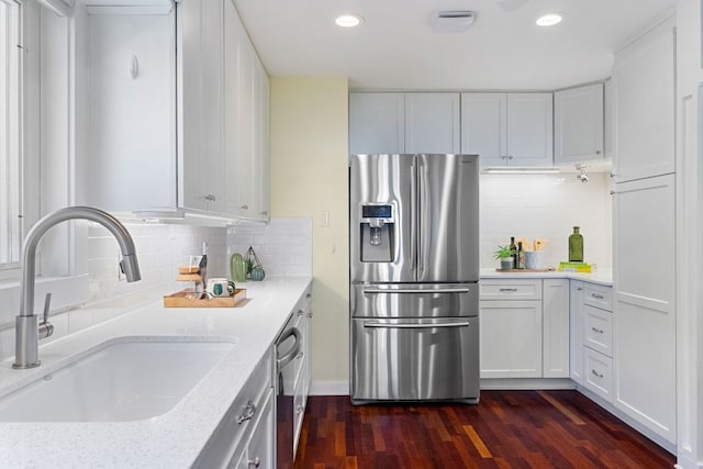 4419 Sinclair Ave, Austin, TX 78756 - kitchen featuring stainless steel refrigerator with ice dispenser, a sink, recessed lighting, dark wood finished floors, and backsplash