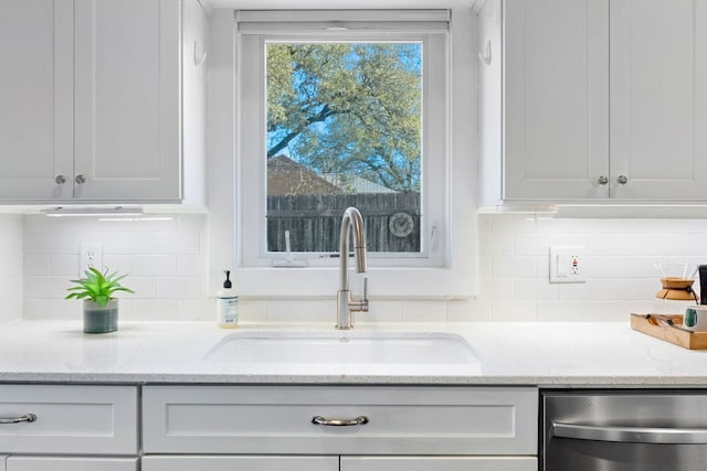 4419 Sinclair Ave, Austin, TX 78756 - kitchen with a sink, stainless steel dishwasher, white cabinets, and light stone countertops