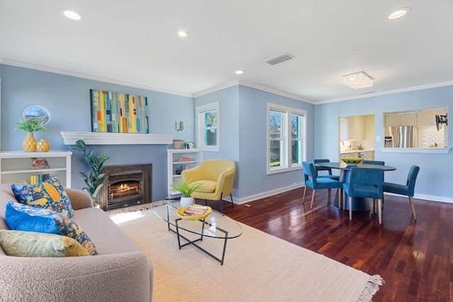 4419 Sinclair Ave, Austin, TX 78756 - living area with crown molding, baseboards, wood finished floors, a fireplace with flush hearth, and recessed lighting
