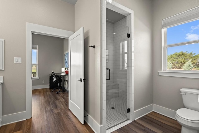 200 County Road 246, Florence, TX 76527 - bathroom featuring toilet, a stall shower, wood finished floors, and baseboards