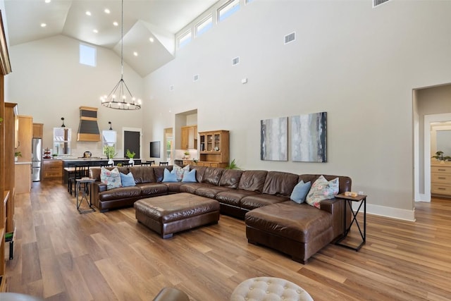 200 County Road 246, Florence, TX 76527 - living area featuring high vaulted ceiling, a chandelier, light wood-style floors, recessed lighting, and healthy amount of natural light
