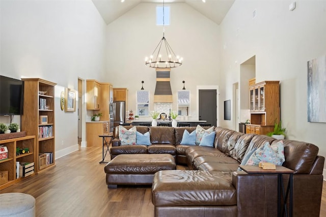 200 County Road 246, Florence, TX 76527 - living area featuring a chandelier, high vaulted ceiling, wood finished floors, and baseboards