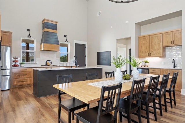200 County Road 246, Florence, TX 76527 - dining space featuring a towering ceiling and light wood-style floors