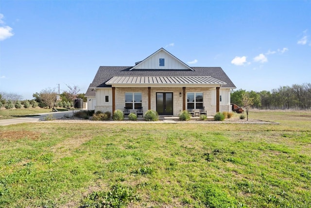 200 County Road 246, Florence, TX 76527 - modern farmhouse style home with a front lawn, a porch, a standing seam roof, and board and batten siding