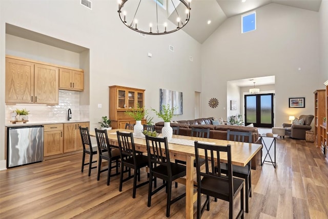 200 County Road 246, Florence, TX 76527 - dining room featuring a chandelier, light wood-style flooring, and high vaulted ceiling